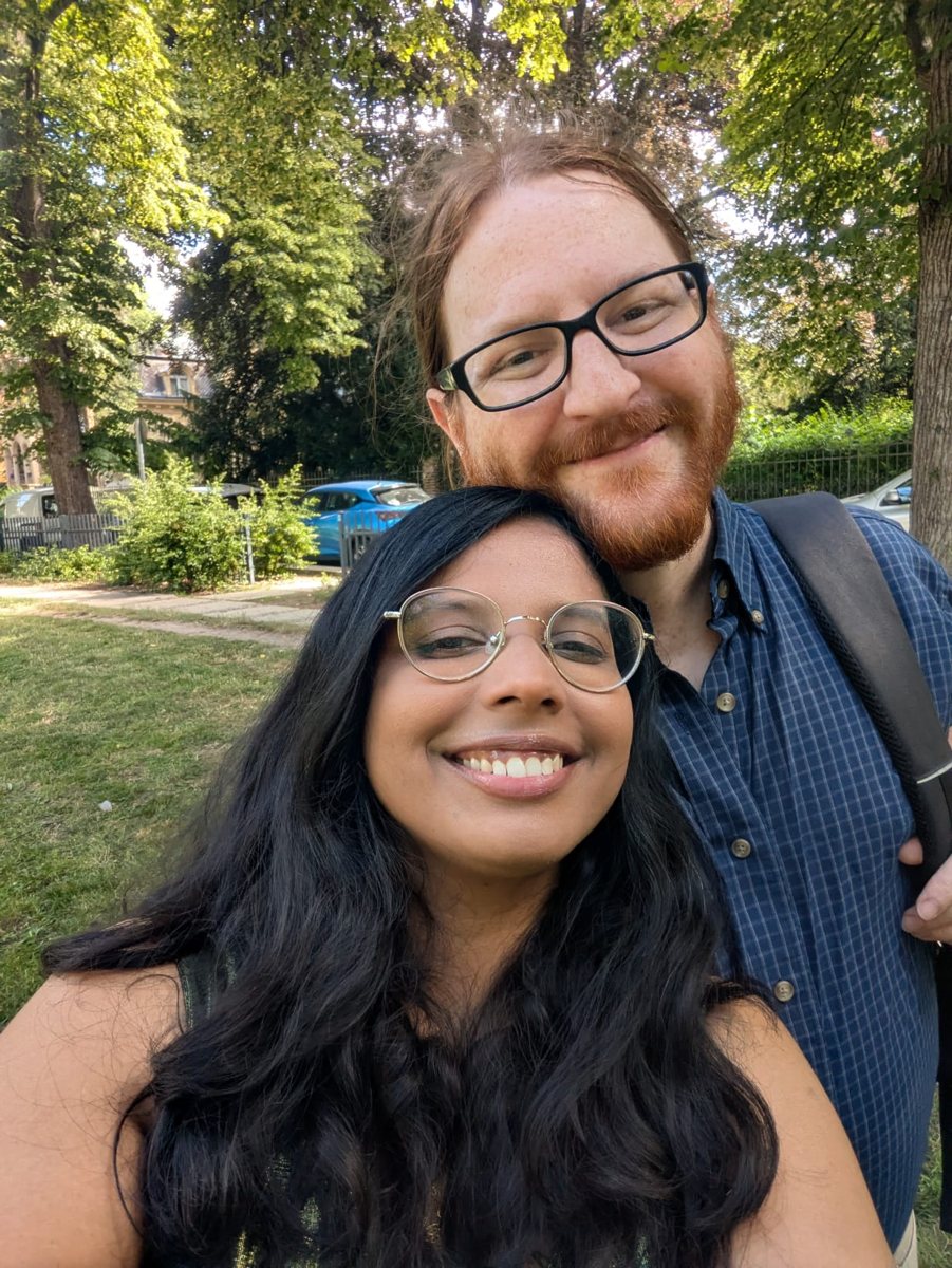 Ben and his wife Jay smiling outdoors in a leafy park